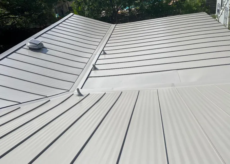 Solar attic fan installed on a metal roof for Roof Ventilation in Hickory Creek